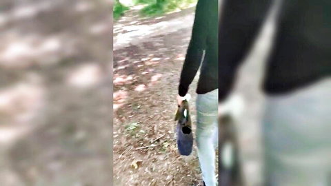 Blurry outdoor thumbnail of woman walking in park wearing green jacket and white leggings