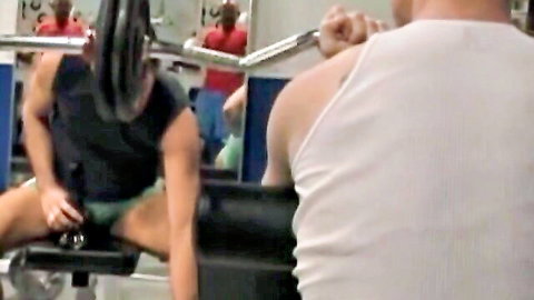 Tim Rusty exposes cock on preacher curl bench while Joey O'Bryan watches in gym workout