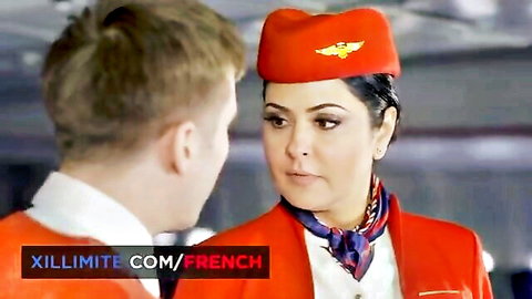 Brunette flight attendant in red uniform facing man in airport roleplay