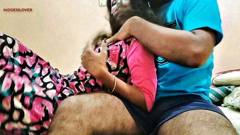 Indian bhabhi in pink top and floral skirt hugged intimately by man in blue shirt