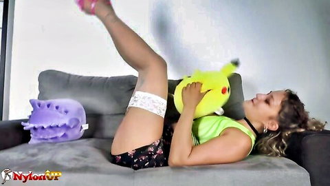 Curvy Lady Maat in stockings, garter belt, legs up holding Pikachu plush