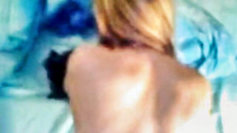 Blonde MILF nude from behind in orgasmic arch on blue sheets