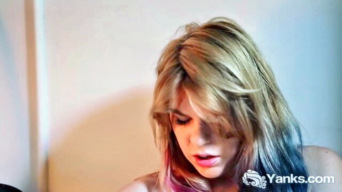 Blonde guitar chick in pink top showing cleavage