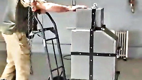 Masked beauty with angelic eyes caged and transported in fetish scene