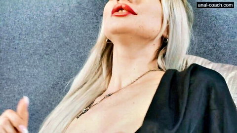 Angelina Frost blonde in black dress, red lips, seductive thumbs up tease