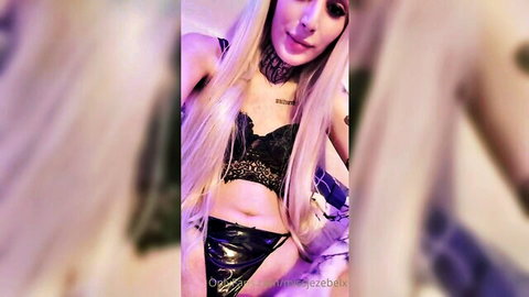 Miss Jezebel in seductive black lace lingerie, blonde hair and tattoos
