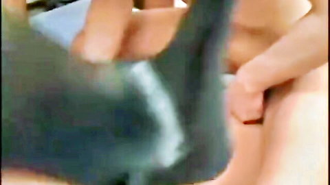 Hand stroking massive erect cock with hairy balls as blue shorts pulled aside closeup