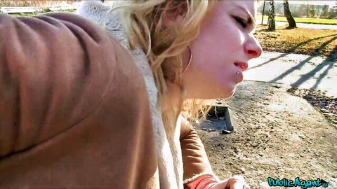 Blonde in fur coat grimacing intensely during outdoor public blowjob POV
