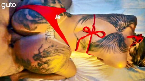 Tattooed Melissa in red thong, flaunting inked ass and wing tattoos