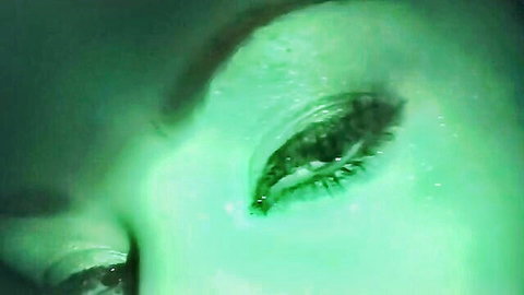 Charley Chase's seductive green-tinted eye close-up in steamy porn scene
