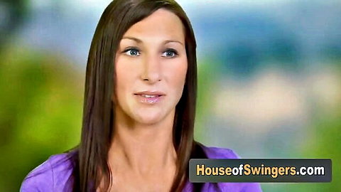 Sexy brunette babe in purple top smiling for House of Swingers promo
