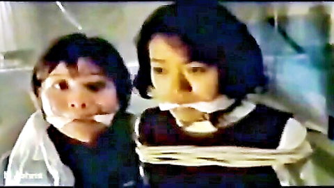 Two bound Asian women gagged in school uniforms, intense bondage scene