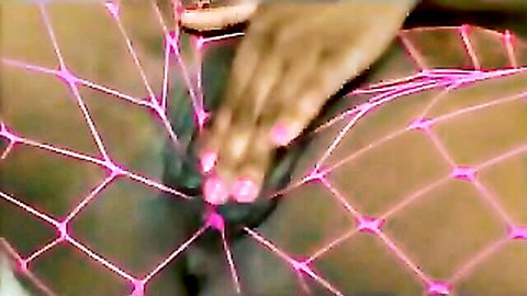 Toni Sweets masturbates through pink fishnet stockings close-up