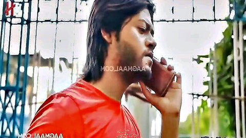 Indian man with long hair and beard on phone call in red shirt, Makan Malkin 2022 hot film