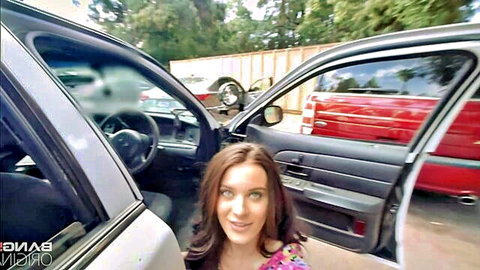 Lana Rhoades smiles in police car wearing floral dress
