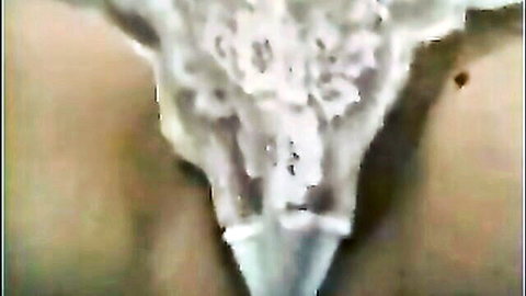 Close-up of woman in white lace panties masturbating hidden, explicit view