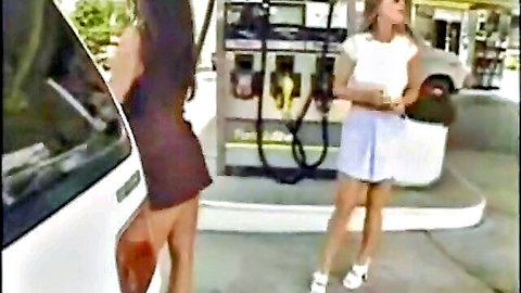 Two hot women in mini outfits teasing at gas station pumps