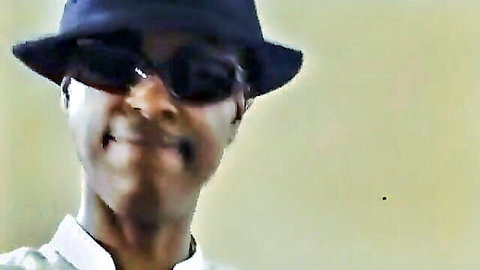 Smirking black man in fedora and sunglasses, teasing blindfold vibe in Pink Press adult thumbnail