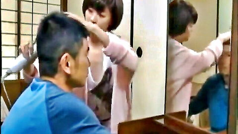 Japanese father and daughter in intimate hair styling moment