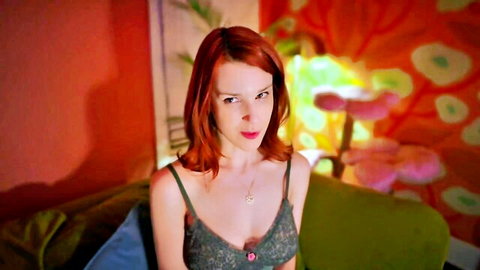 Redhead MILF in lace lingerie sitting seductively