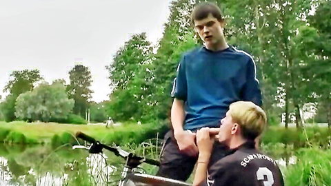 Two cute young guys in outdoor blowjob by river with bikes