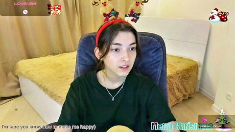 EmmaCherry7 in Christmas reindeer headband, smiling on webcam stream