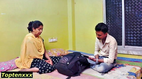 Indian woman in yellow saree sits with man on bed in amateur adult scene