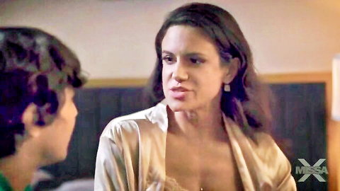 Brunette MILF in open silk robe exposing medium tits cleavage to young stud in bedroom