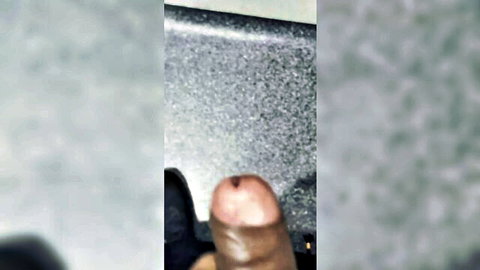 Blurry closeup of dark-skinned big toe protruding from black shoe with visible nail bed foot fetish