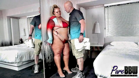BBW with huge tits and thick ass in skimpy red sling bikini poses naughtily with bald stud in mirror selfie