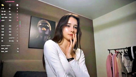 Dialae in Chaturbate webcam, thoughtful pose in white top, topless flexibility show