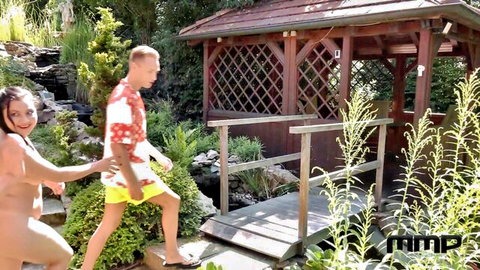 Kaira Love nude pulling boyfriend in outdoor garden tease