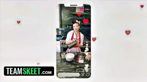 Sexy Asian MILF in polka-dot apron stirring bowl in kitchen