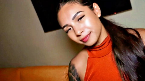 Viera May, sexy Latina model in orange top, smiling at camera