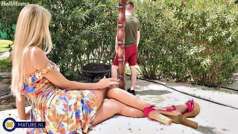 Blonde woman in floral dress sits outdoors with Sam Bourne in red shorts