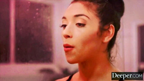 Seductive brunette with glossy pink lips parted in teasing blowjob pose