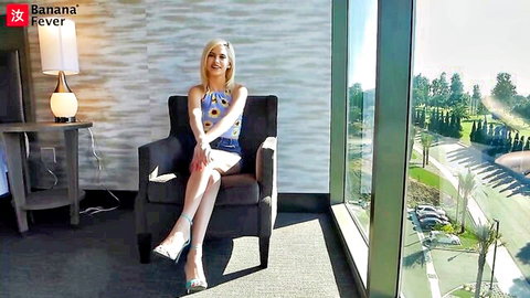 Blonde Kiara Cole sits seductively in short dress and heels