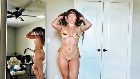 Andi Bagus in skimpy yellow striped bikini try-on pose