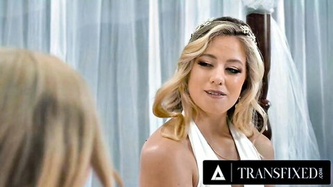 Crystal Thayer as blonde bride in white dress with veil, gazing intently