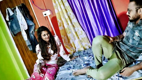 Sexy young Indian babe in pink pajamas cuddling with boyfriend on bed romantic foreplay