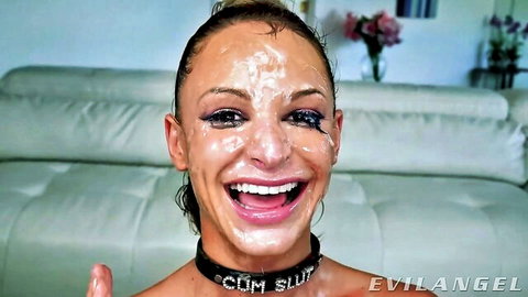 Blonde cum slut with facial cumshot, smiling in blowbang scene