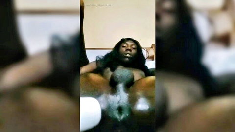 Ebony woman spreading legs exposing pussy with toy insertion