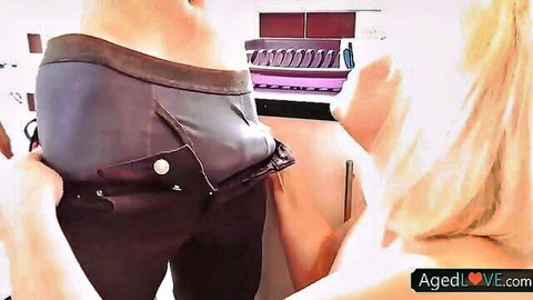 Blonde mature woman pulls down man's pants exposing his underwear bulge and ass in kitchen