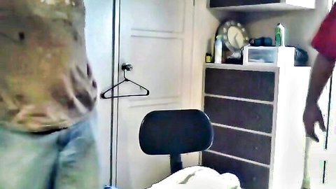 Man standing with jeans pulled down exposing bare ass cheeks in bedroom