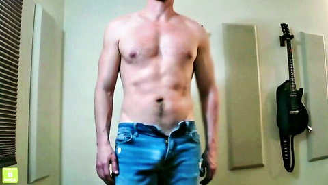 Muscular shirtless guy with hairy chest unzipping jeans teasing bulge