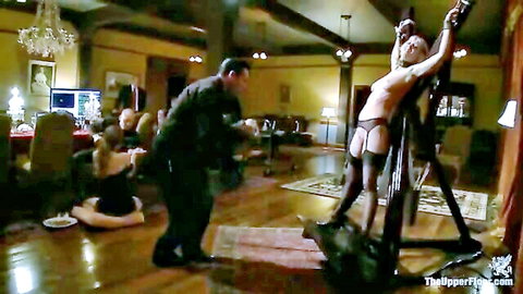 Blonde house slave bound in lingerie, teased by sadistic male guests