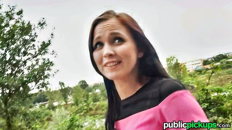 Joanna Black smiles teasingly outdoors in pink top, public pickup vibe