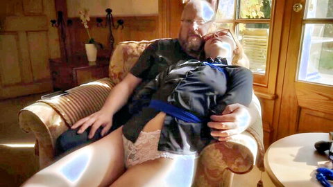 Scarlett bound on man's lap in first BDSM session, lace panties exposed