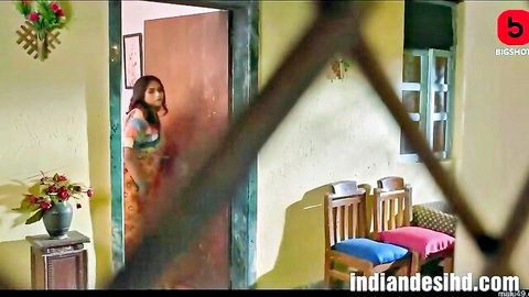 Indian woman in green saree peeking curiously from door in Jabran Ullu series