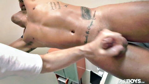 Muscular Latino man receiving intense handjob from partner in steamy gay scene